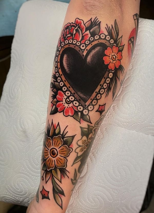 Forearm Tattoo with Traditional Black Heart Design